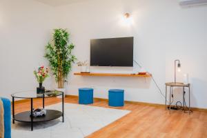 a living room with a flat screen tv on a wall at Peaceful Nest In City Center - Happy Rentals in Zagreb +28 photos