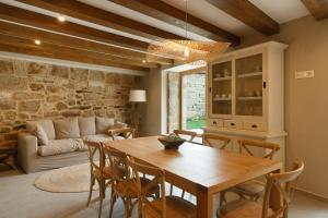 a living room with a wooden table and chairs at Casa San Blas in Verín