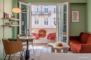 a living room with a couch and a table at Aparthotel AMMI Nice Lafayette in Nice