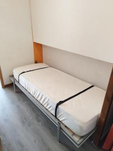 two beds in a small room with white walls at Studio - Les Hauts d'Azur in Saint Pierre La Mer