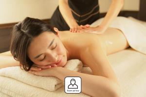 a woman getting a massage in a towel at ZONK HOTEL Nakasu in Fukuoka +53 photos