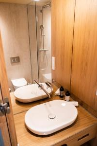 菲尔德施塔特Das Kaya Hotel Stuttgart Airport Messe的带白色水槽和淋浴的浴室