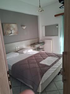 A bed or beds in a room at Alexandros