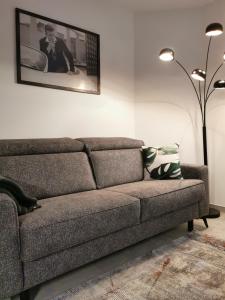 a couch in a living room with a picture on the wall at SmartApart - Design Apartment - Favorite Place - Full Equipment - Public Transport in Nürnberg