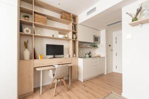 a home office with a desk and a tv at Be Casa Alcobendas in Alcobendas