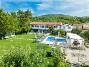 an aerial view of a house with a swimming pool at Villa Medo in Drinovci