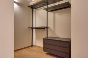 a walk in closet with black drawers and shelves at Domus Santa Croce in Bergamo