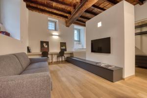 a living room with a couch and a flat screen tv at Domus Santa Croce in Bergamo