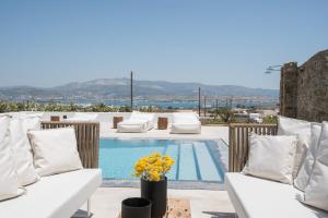 a villa with a swimming pool with white furniture at Oneiro 4BDR Villa in Antiparos Sirocco Villa in Andiparos