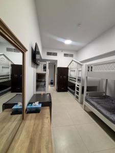 a room with multiple bunk beds in a room at Dubai Airport Hostel in Dubai