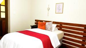 a bedroom with two beds with white and orange pillows at AK Secunda Accommodation in Secunda