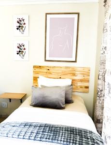 a bedroom with a bed with a wooden headboard at AK Secunda Accommodation in Secunda