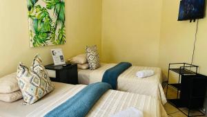 a room with two beds with pillows on them at AK Secunda Accommodation in Secunda