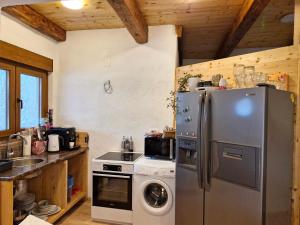 a kitchen with a refrigerator and a washing machine at Villa Stanko Međugorje in Čapljina