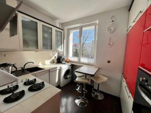 a kitchen with a sink and a stove top oven at Gdynia City Stay in Gdynia