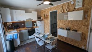 a kitchen with a table and chairs in a room at Félicia in Quend-Plage