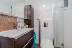 a bathroom with a sink and a toilet and a shower at Boba lovely apartment close to Zrce beach in Gajac
