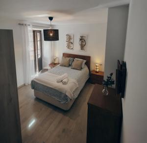 a bedroom with a large bed and a window at Alojamiento Wadi Dar Al-Farah "La Casa de la Alegría de Guadix" in Guadix