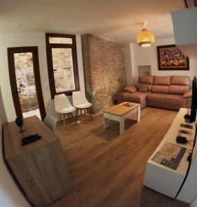a living room with a couch and a table at Alojamiento Wadi Dar Al-Farah "La Casa de la Alegría de Guadix" in Guadix