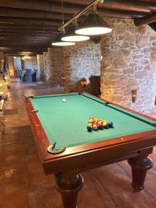 a pool table with balls on it in a room at Finca El Corchito Aracena in Aracena