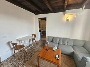 a living room with a couch and a table at Il Nido - Germignaga in Germignaga