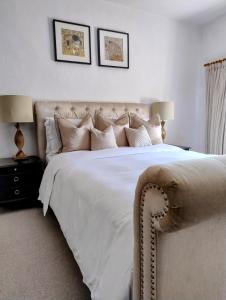 a bedroom with a large bed with white sheets and pillows at Spacious Family Cottage Retreat in North Perrott