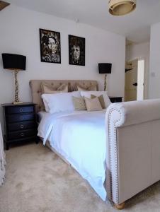 a bedroom with a large white bed and two lamps at Spacious Family Cottage Retreat in North Perrott +31 photos