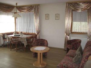 a living room with a table and a table and chairs at Hotel garni zur Linde in Lauf