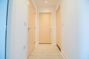 an empty corridor with white walls and a wooden floor at Argyle Place in Glasgow +24 photos