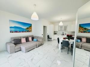 a living room with a couch and a table at Grand View Como Lake Apartment in Abbadia Lariana