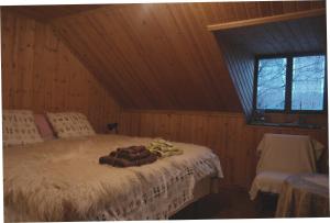a bedroom with a bed in a wooden room at The Lake's House in Kryonérion