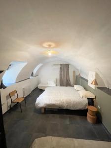 a bedroom with a bed and a table and a chair at Mas Du tel, moment nature in Sumène