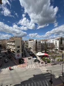 a busy city street with buildings and a cloudy sky at Casa Doro Α2 in Larisa