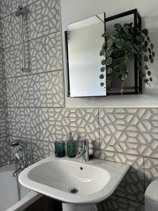 a bathroom with a sink and a mirror at Blackley Rustic Gem A Manchester Suburb Hideaway in Manchester