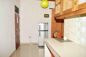 a kitchen with a refrigerator in the middle of a room at Sampathaa Residence in Negombo