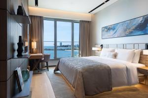 a bedroom with a bed and a desk and a window at JW Marriott Hotel Istanbul Marmara Sea in Istanbul