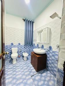 a bathroom with a toilet and a sink at Millennium Luxury Apartments in Negombo +49 photos