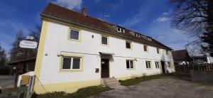 a white building with a brown roof at 2-Rent Group Hostel Apartments EVE74 in Munich
