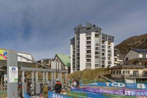 a group of people standing in front of a building at Le Nid de Gourette - Au Pied des Pistes in Eaux-Bonnes