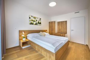 a bedroom with a large bed in a room at DownTown Suites Andel in Prague +20 photos