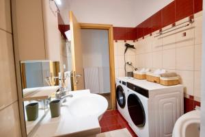a bathroom with a washing machine and a sink at LUXE COASTAL RETREAT Apartment in Alexandroupoli +87 photos