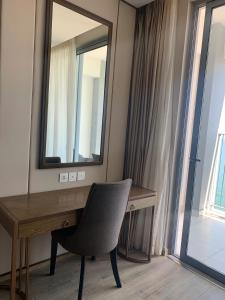 Habitación con escritorio con espejo y silla. en Panorama Nha Trang Skydream, en Nha Trang 1 foto más
