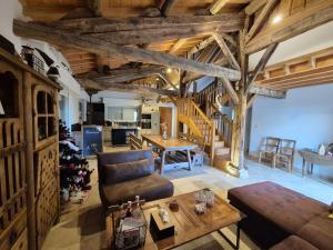 a living room with a couch and a christmas tree at Corps de Ferme Labarthe à Pimbo in Pimbo