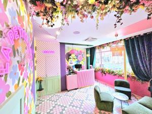 a salon with pink and purple walls and flowers at Hotel La Petite Rosa in Paris +74 photos