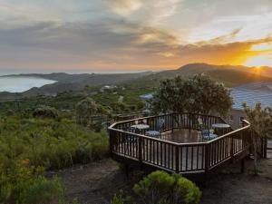 a view of the sunset from a balcony of a house at Pincushion Heights in Brenton-on-Sea