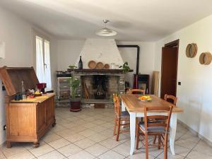a living room with a table and a fireplace at R&B Dalla Licia in San Giorgio di Piano