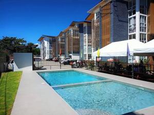 a swimming pool in front of a building at Janna's Condo in Mactan in Lapu Lapu City