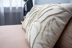 a close up of a white blanket on a bed at Balkan Tower Deluxe Ultra in Gabrovo +23 photos
