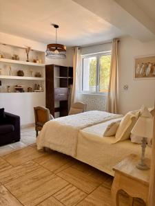 a bedroom with a large bed and a window at Le Mas des Mirabelles in Cabannes +24 photos