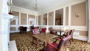 a dining room with a table and chairs at Russ Hill Hotel in Charlwood